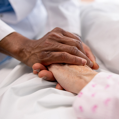 Doctor holding patient hand