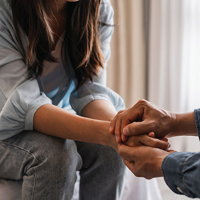 Two people holding hands