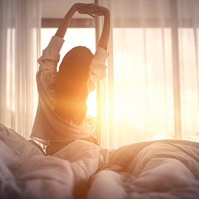 Person stretching in bed
