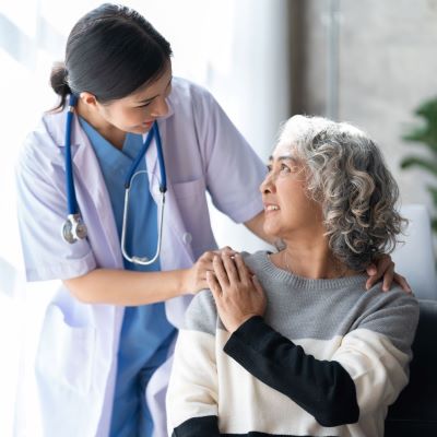 Healthcare worker reassuring a patient, both smiling