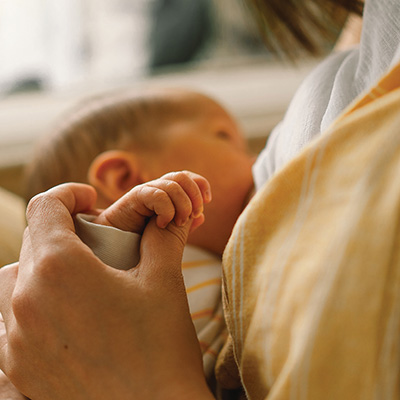 Baby holding onto person's hand