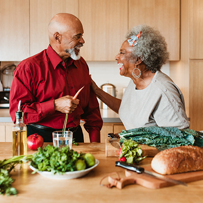 Elderly African-American couple preparing a healthy meal 