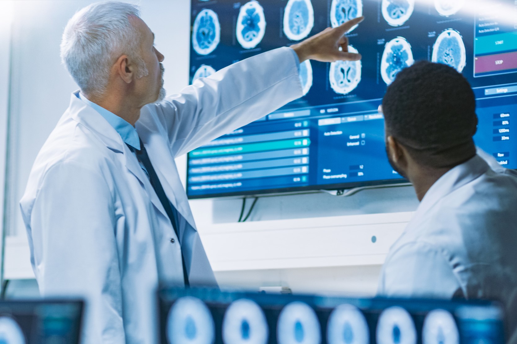 Man pointing at brain scans